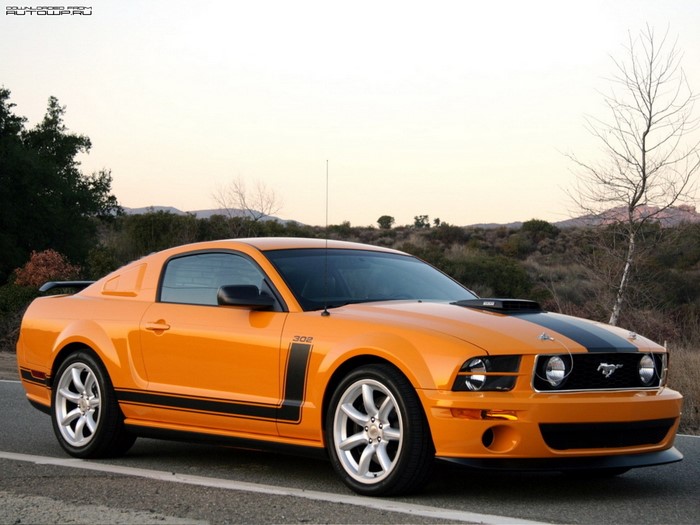 Orange Ford Mustang Boss 302 parked on a road