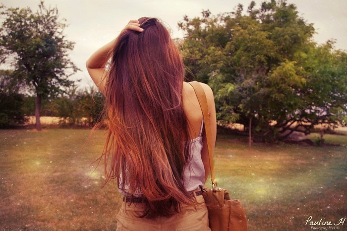 Woman with long brown hair in a field