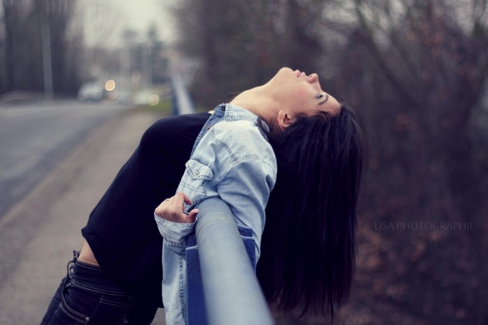 Woman leaning on railing outdoors
