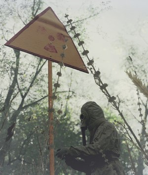 Chernobyl radiation warning sign and gas mask wearer