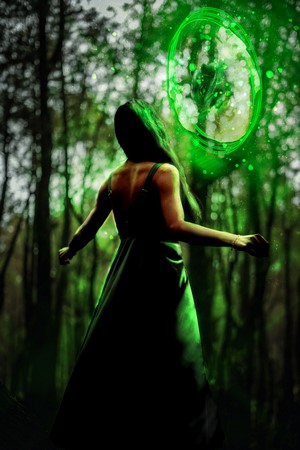 Woman in green dress near a green portal in a forest