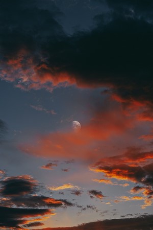 Moon and clouds during sunset