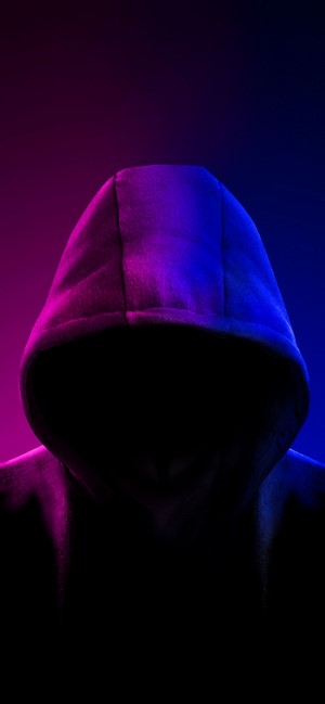 Anonymous person in a hood with pink and blue lighting