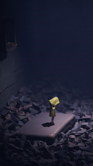 Six from Little Nightmares holding a yellow object