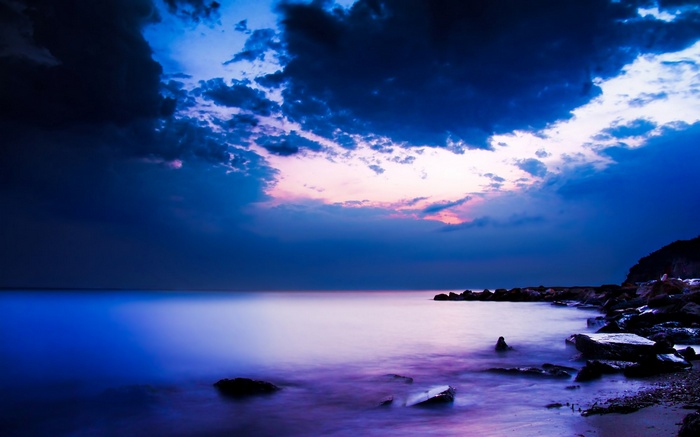 Dark Clouds Over a Purple Ocean at Dusk