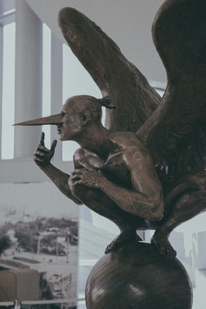 Bronze sculpture of a winged human with a bird-like beak