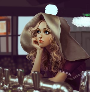 Woman with blonde wavy hair wearing a hat