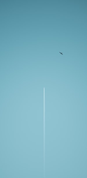 Airplane leaving a contrail in a clear blue sky