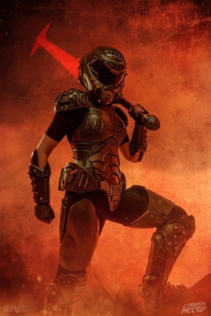 Cosplayer in DOOM Eternal armor holding a plasma sword