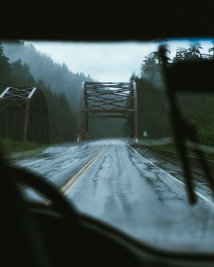 Driving on a wet road under a bridge in the rain