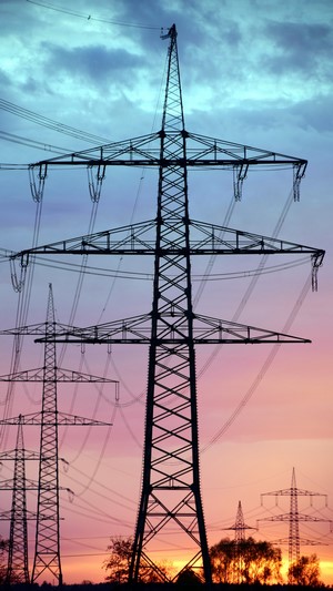 Power lines and pylons at sunset