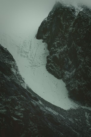 Snowy mountains shrouded in mist, aerial view