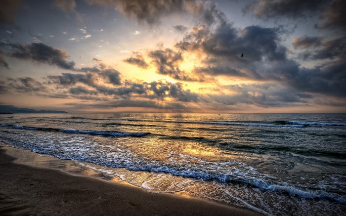 Sunrise over the ocean with dramatic clouds