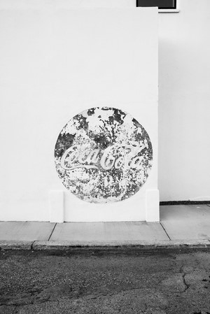 Coca-Cola logo on a weathered wall