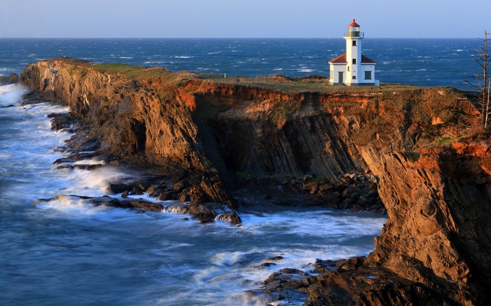 Lighthouse on a cliff overlooking the ocean