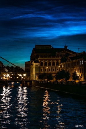 Noctilucent clouds over St. Petersburg canal at night