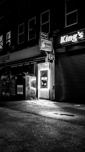 Night scene with ATM outside Costcutters and King's shop