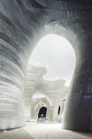 Modern architecture with cave-like concrete structures and lighting