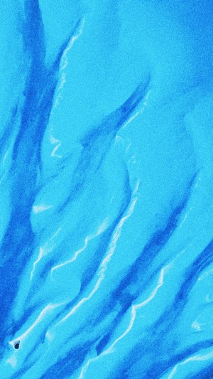 Sand dunes with cyan and blue patterns
