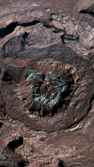 Aerial view of a crater with colorful mineral deposits