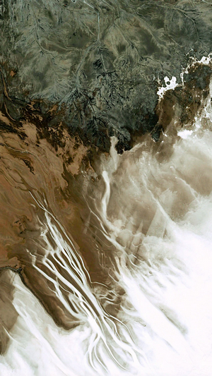 Satellite view of arid landscape with river delta