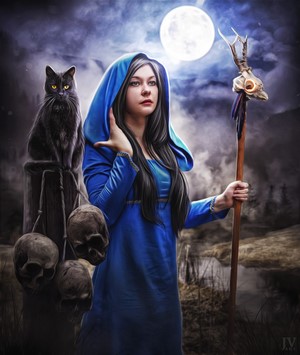 Witch with black cat and staff under moonlight