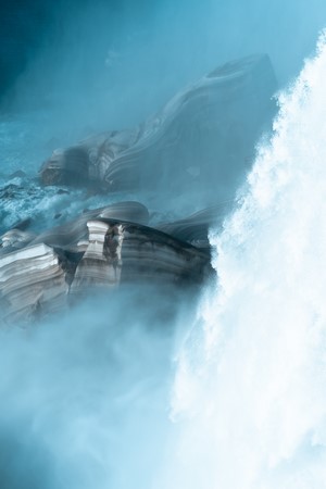 Waterfalls and rock formations in mist