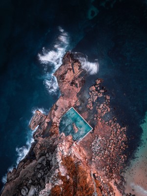 Aerial view of a rock pool on a rocky coastline