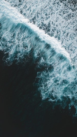 Aerial view of ocean waves crashing