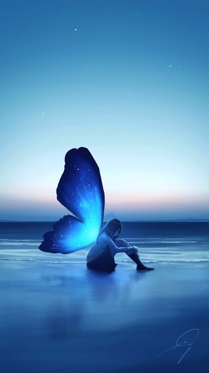 Girl with butterfly wings on a beach