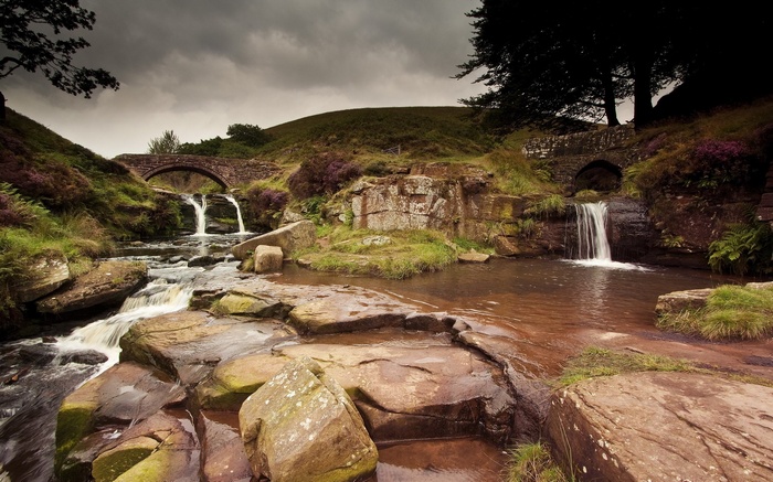 Stone bridges over waterfalls in a rocky landscape