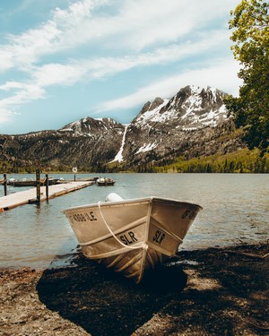 Boat on a lake with snowy mountains