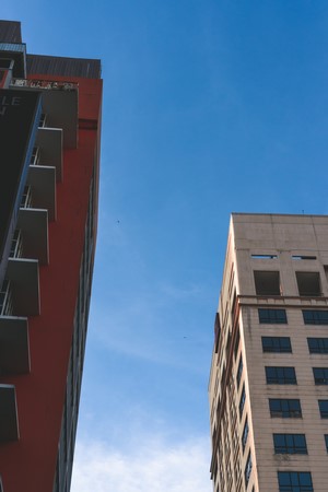 Two modern buildings against a blue sky
