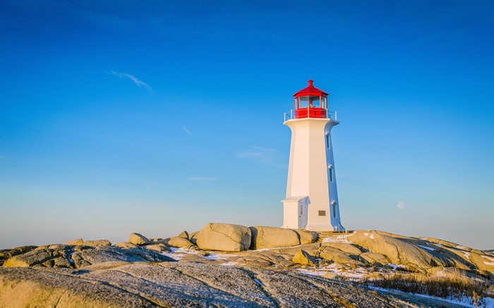 Peggy's Cove Lighthouse under a clear blue sky
