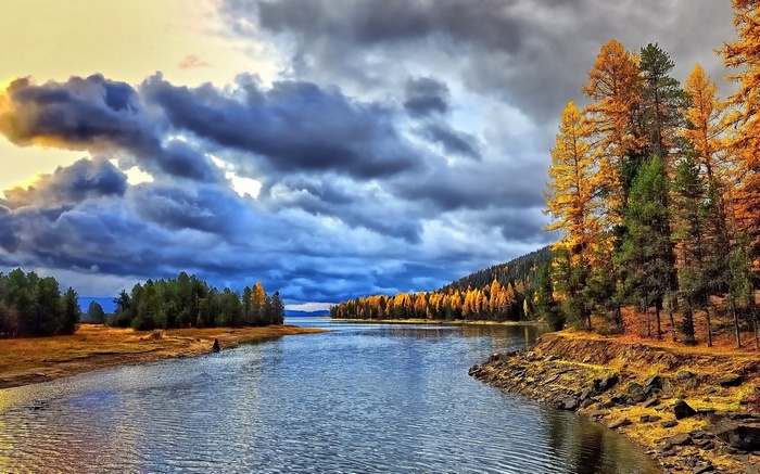 Autumn lake with dramatic clouds and trees