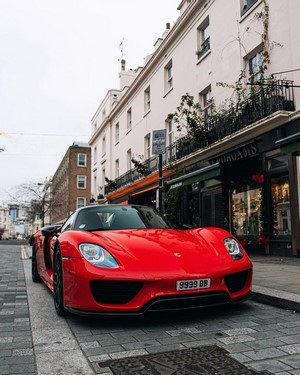 Red Porsche 918 Spyder parked on a London street