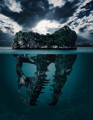 Island and underwater dinosaur skull reflection