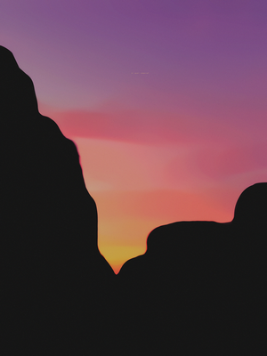 Silhouette of mountains against a colorful sunset sky