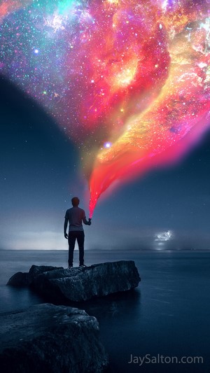 Man holding a flashlight creating a galaxy