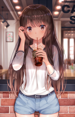 Girl drinking iced coffee at a cafe