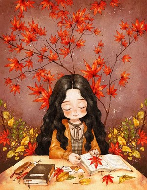 Girl reading a book surrounded by autumn leaves