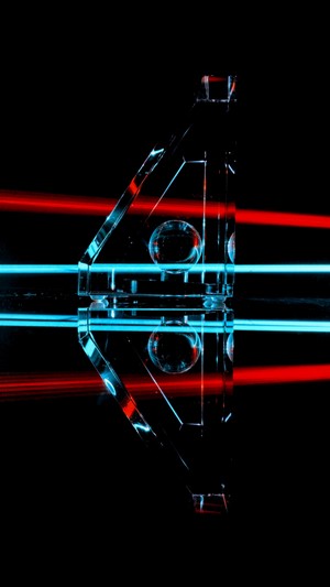 Glass prism with red and cyan light beams