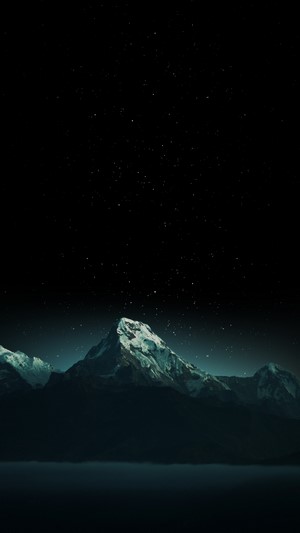 Snow-capped mountains under a starry night sky