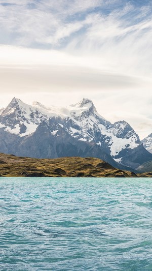 Snow-capped mountains over a turquoise lake