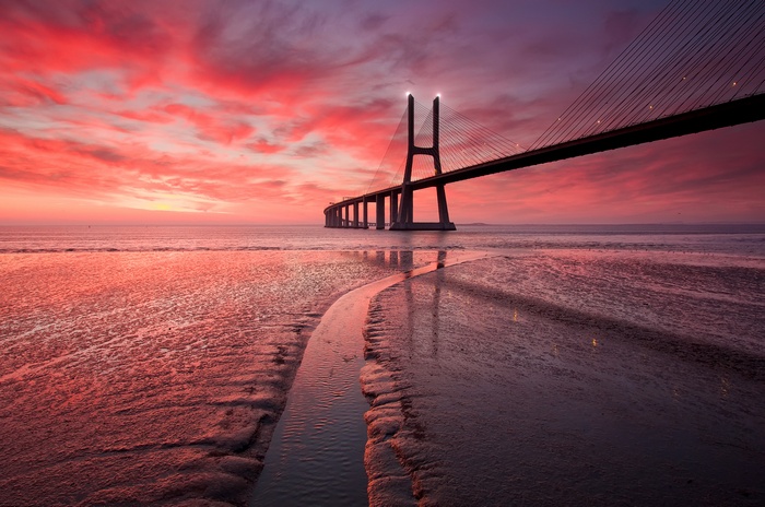 Vasco da Gama Bridge at sunset over Tagus River, Portugal