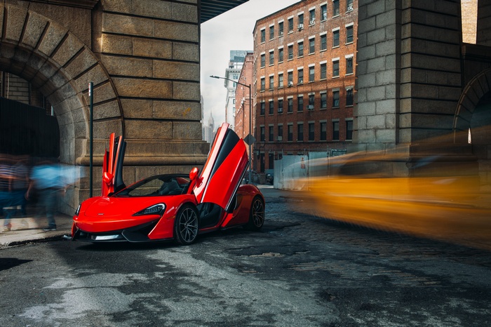 Red McLaren 570S Spider parked under a bridge in New York
