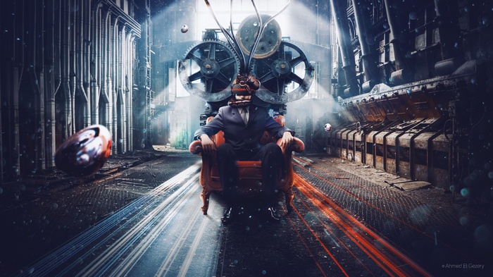 Man in Chair with Machine in Factory