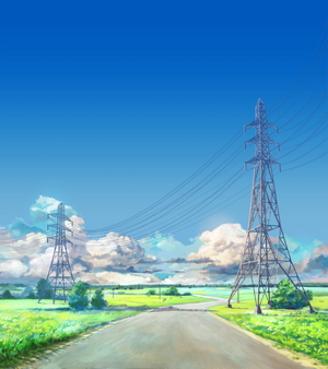Road with power lines in a field under blue sky