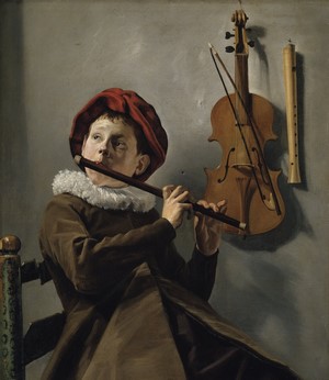 Boy playing flute with violin and recorder