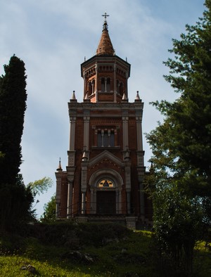 Brick tower with a cross on top in Italy